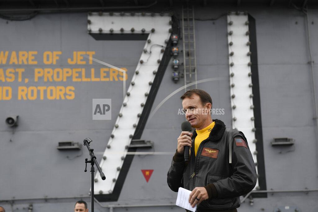 Seaman Apprentice Nicholas Huynh FILE - In this Nov. 15, 2019, file photo U.S. Navy Capt. Brett Crozier, then commanding officer of the aircraft carrier USS Theodore Roosevelt (CVN 71), addresses the crew during an all-hands call on the ship's flight deck while conducting routine operations in the Eastern Pacific Ocean. Crozier, the dismissed captain of the U.S. Navy aircraft carrier, knew he was jeopardizing his military career when he broke protocol and sent a now-famous email warning of possible sailor deaths due to a coronavirus breakout on board, but he did so in an urgent effort to help avoid a "larger catastrophe," he wrote in a witness statement obtained by the San Francisco Chronicle. (Mass Communication Specialist 3rd Class Nicholas Huynh/U.S Navy via AP, File)
