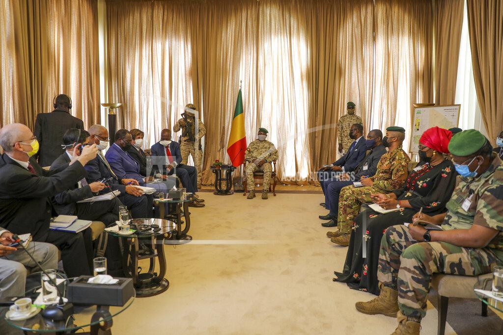 Harandane Dicko Malian Transition President Col. Assimi Goita, center, holds a meeting with a United Nations Security Council mission led by Kenya's Ambassador to the U.N. Martin Kimani in Bamako, Mali, Sunday Oct. 24, 2021. The mission that is visiting Mali this weekend to assess the security situation is urging Mali's authorities to set elections for February 2022 to meet agreements reached with a West African regional bloc after a coup last year. (AP Photo/Harandane Diko)