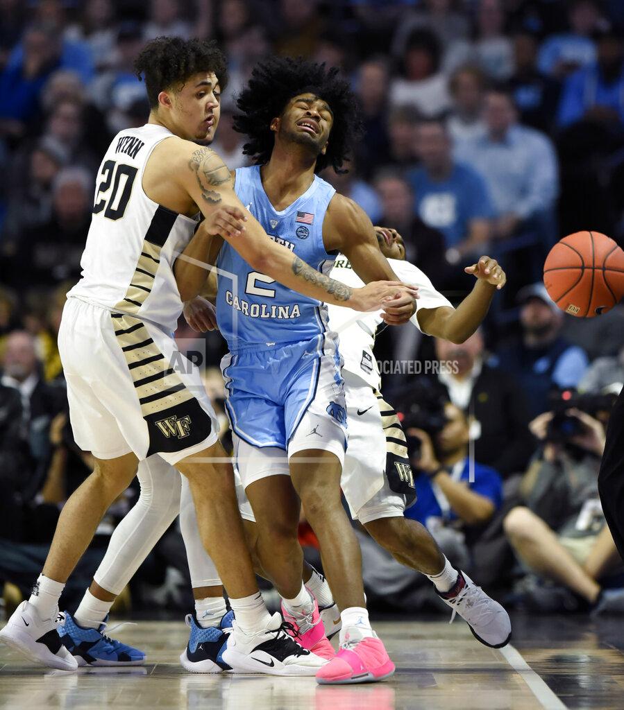 Woody Marshall Wake Forest's Michael Wynn (20), Brandon Childress (0) and North Carolina's Coby White (2) collide as they all chase down a loose ball during the first half of an NCAA college basketball game in Winston-Salem, N.C., Saturday, Feb 16, 2019. (AP Photo/Woody Marshall)