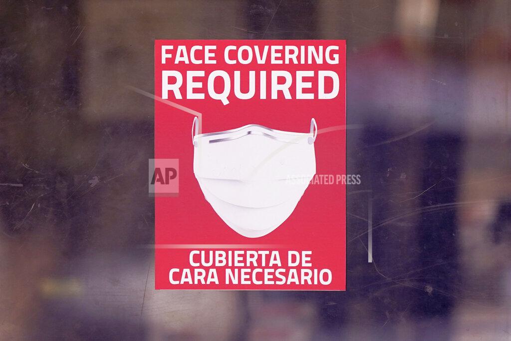 Lm Otero A mask required sign is displayed on the entrance to a business Tuesday, March 2, 2021, in Dallas. (AP Photo/LM Otero)
