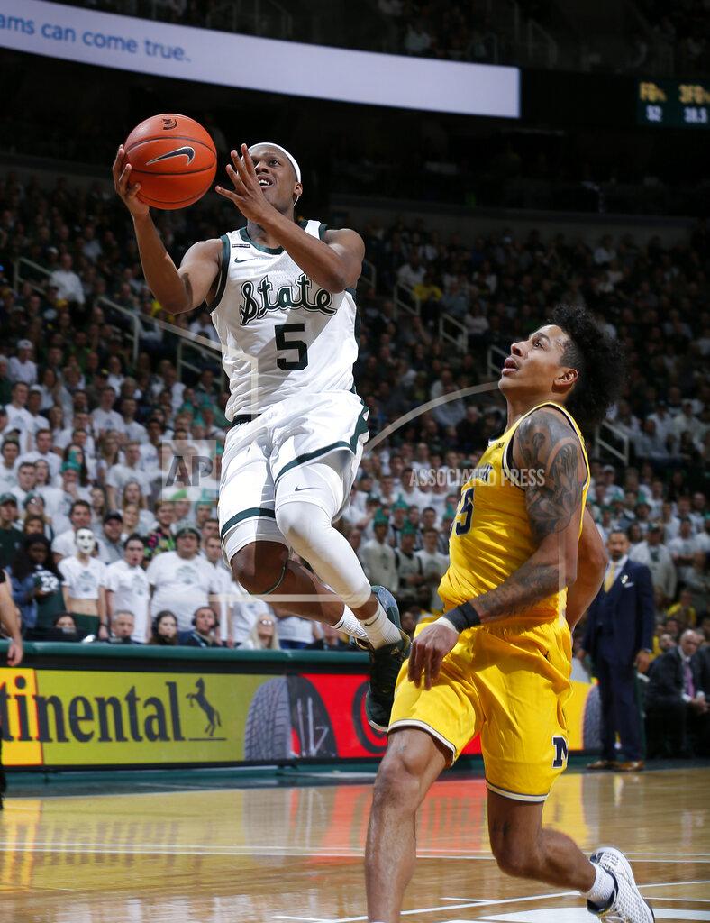 Al Goldis Michigan State's Cassius Winston, left, goes up for a layup against Michigan's Eli Brooks during the second half of an NCAA college basketball game, Sunday, Jan. 5, 2020, in East Lansing, Mich. (AP Photo/Al Goldis)