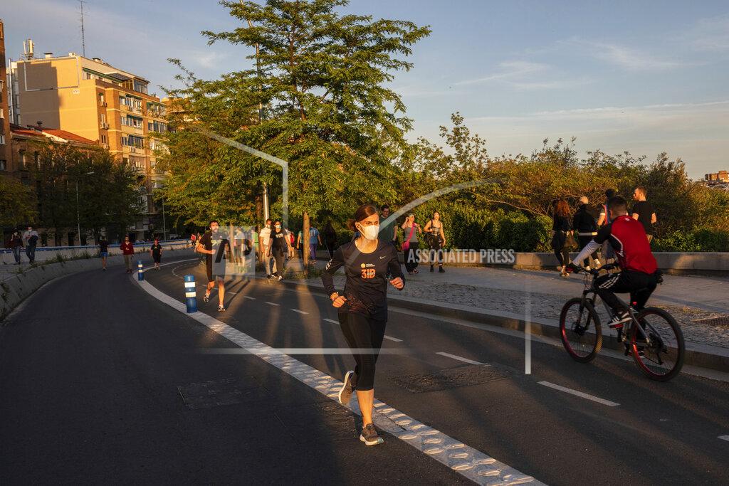 Bernat Armangue FILE - In this Saturday, May 2, 2020 file photo, people exercise in Madrid, Spain after Spaniards were able to go outdoors to do exercise for the first time in seven weeks since the lockdown began to battle the coronavirus outbreak. High-performance athletes were allowed to resume training this week but some reported being harassed by local residents who thought they were breaking confinement rules. (AP Photo/Bernat Armangue, File)