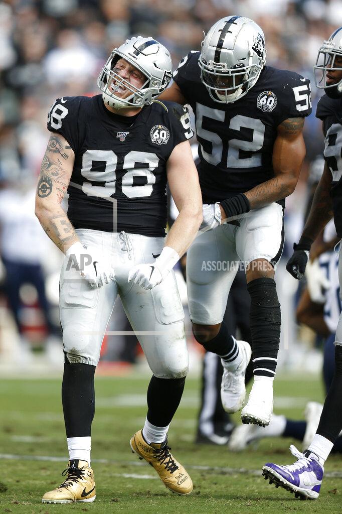 D. Ross Cameron Oakland Raiders defensive end Maxx Crosby (98) reacts next to middle linebacker Marquel Lee (52) during the first half of an NFL football game against the Tennessee Titans in Oakland, Calif., Sunday, Dec. 8, 2019. (AP Photo/D. Ross Cameron)