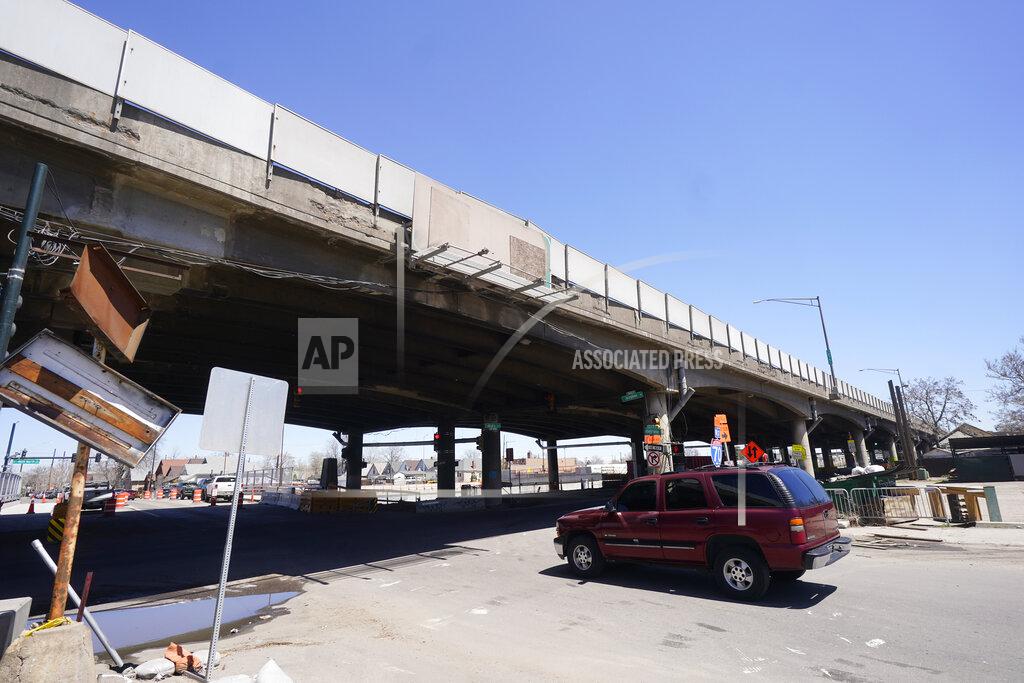 David Zalubowski In this Thursday, April 29, 2021, photograph, a motorist heads under the crumbling elevated portion of Interstate 70 set to be replaced as part of the Central 70 Project workers north of downtown Denver. The elevated roadway that has served as Interstate 70 will be demolished as part of the 10-mile-long project, which will cost $1.2 billion by completion by winter 2022. (AP Photo/David Zalubowski)