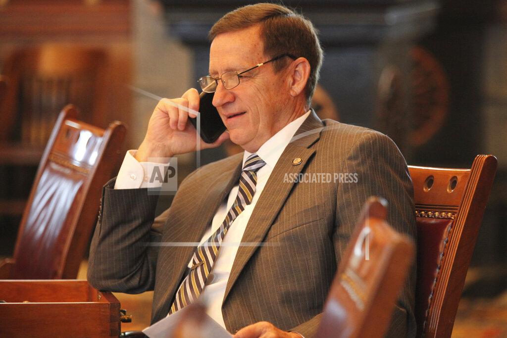 John Hanna Kansas state Sen. Dennis Pyle, R-Hiawatha, speaks on his phone during a break in the Senate's session, Thursday, May 6, 2020, at the Statehouse in Topeka, Kan. Pyle and other conservative Republicans want to tie an increase in funding for public schools to proposals to help parents move their children from public to private schools. (AP Photo/John Hanna)