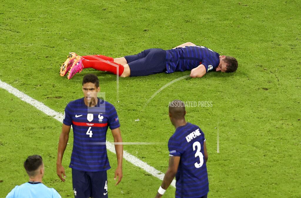 Alexander Hassenstein France's Benjamin Pavard lies on the pitch after Germany's Robin Gosens hit him with his knee during the Euro 2020 soccer championship group F match between France and Germany at the Allianz Arena stadium in Munich, Tuesday, June 15, 2021. (AP Photo/Alexander Hassenstein, Pool)