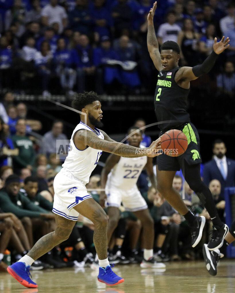 Adam Hunger Seton Hall guard Myles Powell, left, passes around Michigan State guard Rocket Watts (2) during the first half of an NCAA college basketball game Thursday, Nov. 14, 2019, in Newark, N.J. (AP Photo/Adam Hunger)