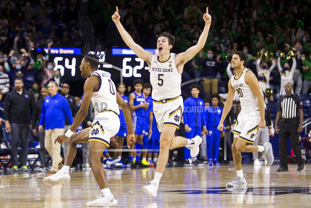 Robert Franklin Notre Dame's Blake Wesley (0), Cormac Ryan (5) and Paul Atkinson Jr. (20) celebrate on the court following their win over Kentucky in an NCAA college basketball game Saturday, Dec. 11, 2021, in South Bend, Ind. (AP Photo/Robert Franklin)