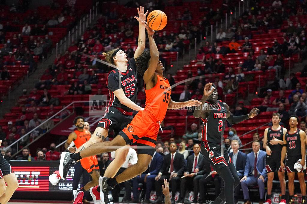 Rick Bowmer Utah guard Gabe Madsen (55) blocks Oregon State forward Glenn Taylor Jr. (35) in the first half during an NCAA college basketball game Thursday, Feb. 3, 2022, in Salt Lake City. (AP Photo/Rick Bowmer)