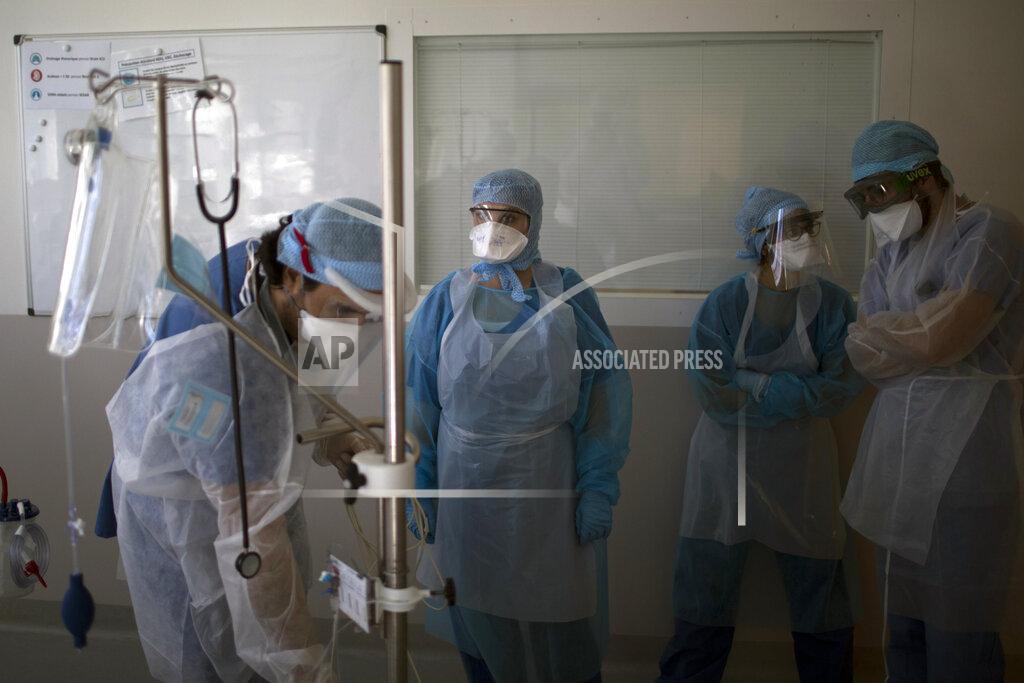 Daniel Cole Nurses stand by as a sixteen-year-old patient is transfered into an ICU room at the La Timone hospital in Marseille, southern France, Tuesday Feb. 2, 2021. COVID patients occupy 88% of the Marseille region's intensive care beds, and virus pressure on French hospitals is steadily rising in recent weeks despite curfews and other restrictions. (AP Photo/Daniel Cole)