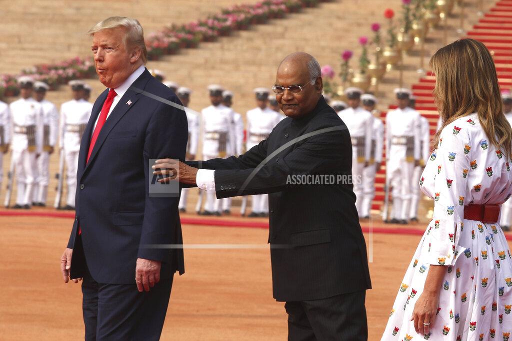 Manish Swarup FILE - In this Feb. 25, 2020, file photo, Indian President Ram Nath Kovind, center, holds the arms of U.S. President Donald Trump, as first lady Melania Trump walks behind them for a photo op during a ceremonial welcome for Trump at the Indian Presidential Palace in New Delhi, India. (AP Photo/Manish Swarup, File)