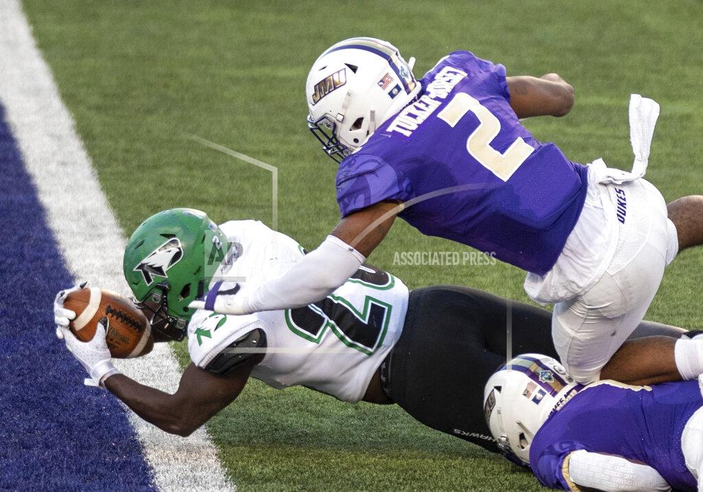 Daniel Lin North Dakota running back Otis Weah (26) dives in under James Madison linebacker Diamonte Tucker-Dorsey (2) for a touchdown during the first half of a quarterfinal game in the NCAA FCS football playoffs in Harrisonburg, Va., Sunday, May 2, 2021. (Daniel Lin/Daily News-Record via AP)