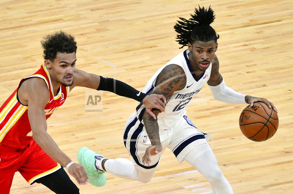 Brandon Dill Memphis Grizzlies guard Ja Morant (12) drives ahead of Atlanta Hawks guard Trae Young in the first half of an NBA preseason basketball game Thursday, Dec. 17, 2020, in Memphis, Tenn. (AP Photo/Brandon Dill)