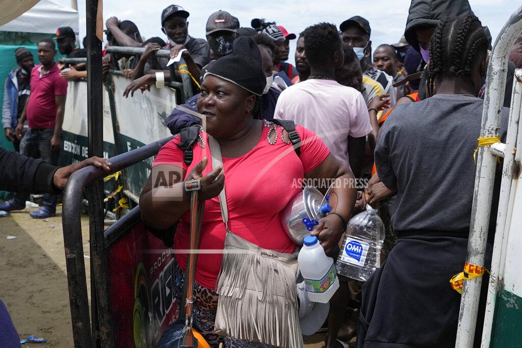 Fernando Vergara Haitian migrants prepare to board a boat that will take them to Acandi, near the border with Panama, from Necocli, Colombia, Monday, Sept. 13, 2021. Migrants have been gathering in Necocli as they move north on their way to the U.S. border. (AP Photo/Fernando Vergara)