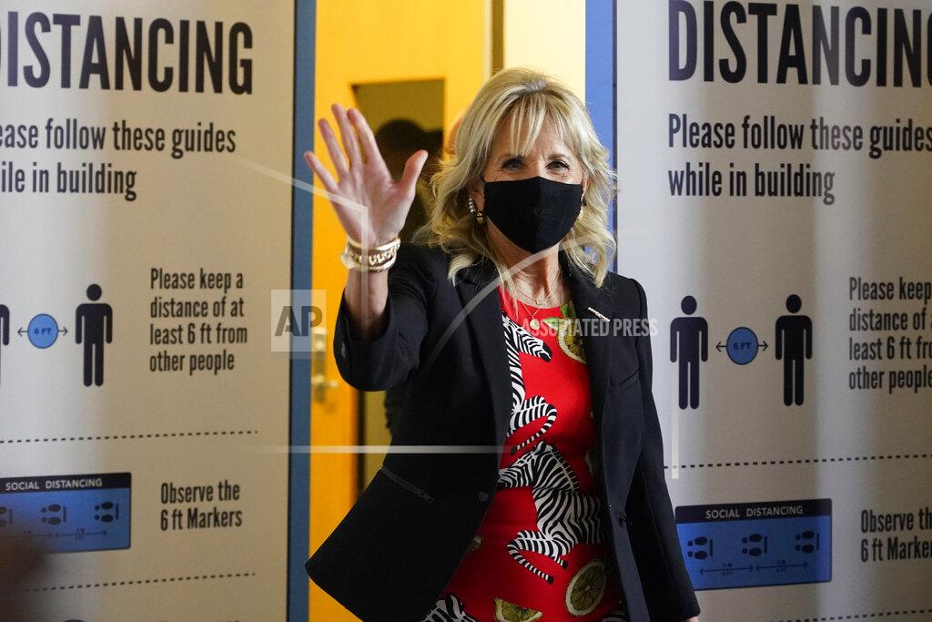 Rogelio V. Solis First lady Jill Biden waves to assembled local media as she makes her way past COVID education posters during a visit to vaccination site at Jackson State University in Jackson, Miss., Tuesday, June 22, 2021, as part of the Biden administration's nationwide tour to reach Americans who haven't been vaccinated and to promote vaccine education. (AP Photo/Rogelio V. Solis)