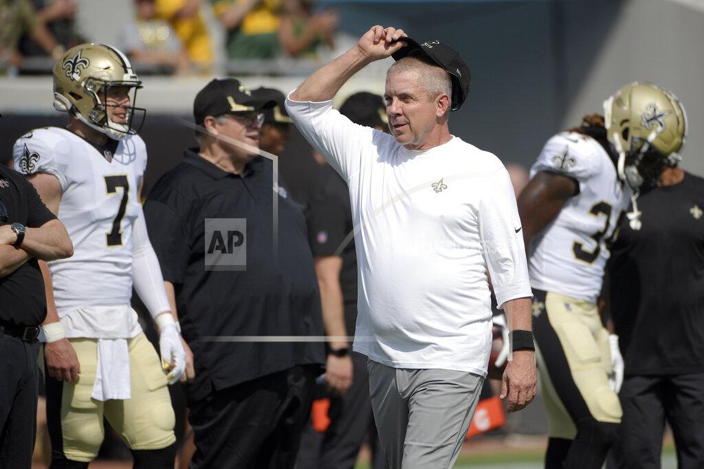 Phelan M. Ebenhack FILE - In this Sunday, Sept. 12, 2021, file photo, New Orleans Saints head coach Sean Payton, center, watches players warm up before an NFL football game against the Green Bay Packers in Jacksonville, Fla. Six unidentified members of the Saints coaching staff, a player and a nutritionist have tested positive for COVID-19, two people familiar with the situation said, Tuesday, Sept. 14, 2021. The people spoke with The Associated Press on Tuesday on condition of anonymity because the team and NFL had not made a public statement about the matter. The names of those who tested positive were not expected to be released in the short term because of federal medical privacy laws. (AP Photo/Phelan M. Ebenhack, File)