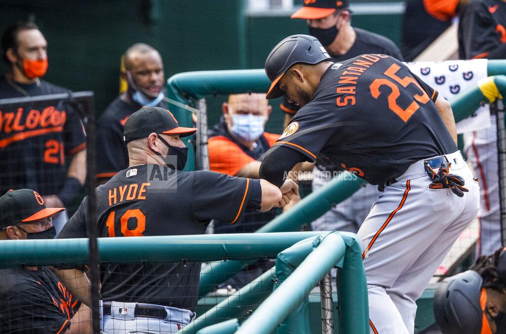Manuel Balce Ceneta Baltimore Orioles Anthony Santander (25) gives an elbow-bump to teammates in their dugout after coring a run during the first inning of a baseball game against the Washington Nationals in Washington, Friday, Aug. 7, 2020. (AP Photo/Manuel Balce Ceneta)