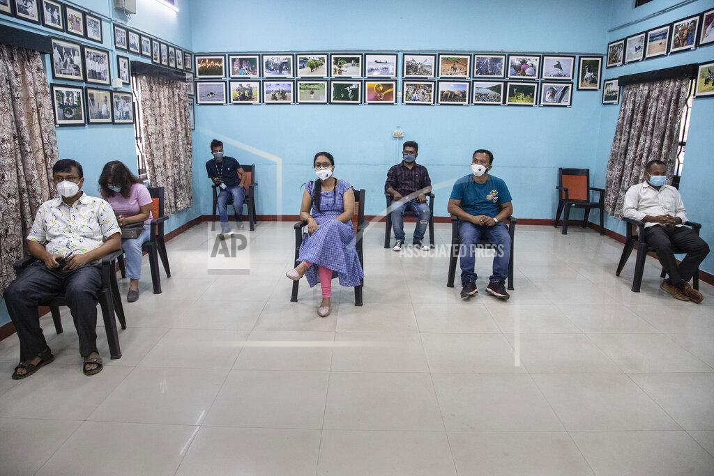 Anupam Nath FILE - In this May 5, 2021, file photo, journalists sit after they got vaccinated against coronavirus at the press club in Gauhati, India. The disparities of the coronavirus pandemic were already stark in India, where access to health care is as stratified and unequal as other parts of its society. Now, the divide along the lines of wealth and technology are further widening that chasm, and many people are falling through the gaps as vaccines remain inaccessible to millions. (AP Photo/Anupam Nath, File)