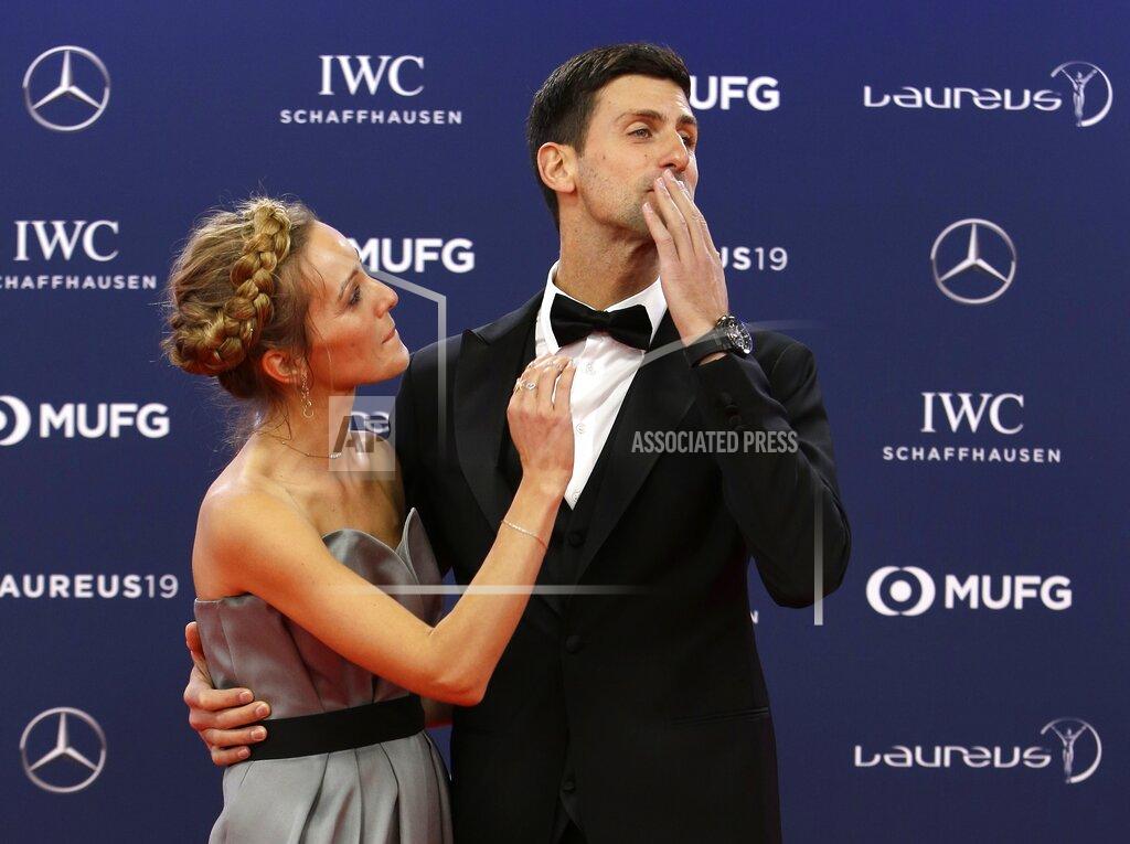 Claude Paris FILE - In this Monday, Feb. 18, 2019 file photo Serbian tennis player Novak Djokovic and his wife Jelena arrive for the 2019 Laureus World Sports Awards. Novak Djokovic has tested positive for the coronavirus after taking part in a tennis exhibition series he organized in Serbia and Croatia. The top-ranked Serb is the fourth player to test positive for the virus after first playing in Belgrade and then again last weekend in Zadar, Croatia. His wife also tested positive. (AP Photo/Claude Paris, File)