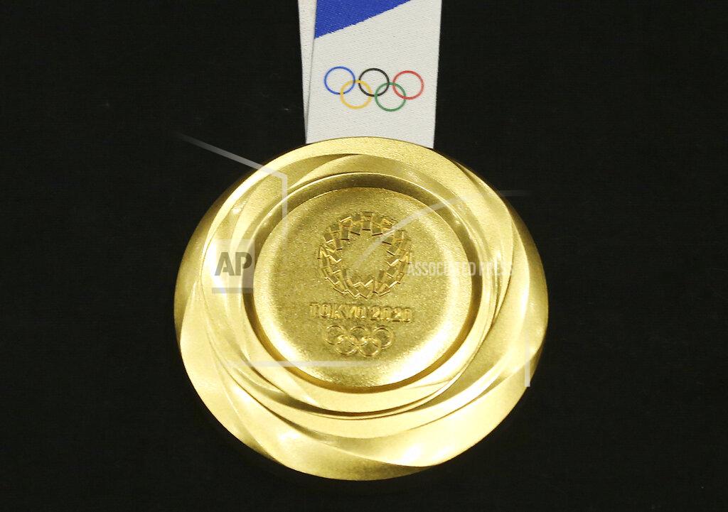 FILE - In this July 24, 2019, file photo, Tokyo 2020 Olympic gold medal is unveiled during a One Year to Go Olympic ceremony event in Tokyo. The Tokyo Olympics are about to open, and predicting the medal count will be more difficult than usual because of the pandemic and the absence of many qualifying events over the last year. (AP Photo/Koji Sasahara, File)