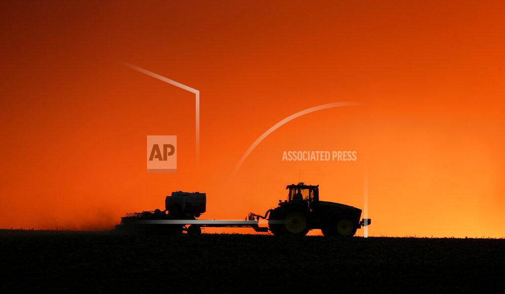 Jim Slosiarek FILE - In this April 20, 2020, file photo, a farmer is silhouetted by the setting sun as a field is planted near Walford, Iowa. Thanks to the government paying nearly 40% of their income, U.S. farmers are expected to end 2020 with higher profit than 2019 and the best net income in seven years, the Department of Agriculture said in its latest farm income forecast. Farmers faced challenges throughout 2020 that included the impact of trade disputes; low prices that drove down cash receipts and weather difficulties. (Jim Slosiarek/The Gazette via AP, File)