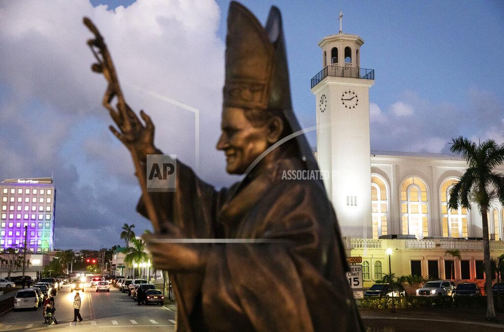 FILE - In this Tuesday, May 7, 2019 file photo, a statue of Pope John Paul II stands outside the island's main cathedral, Dulce Nombre de Maria Cathedral-Basilica, during a Mass in Hagatna, Guam. Over 200 clergy abuse lawsuits led church leaders in the U.S. territory to seek bankruptcy protection, as they estimated at least $45 million in liabilities. Even so, the Archdiocese of Agana’s parishes, schools and other organizations have received at least $1.7 million in coronavirus rescue funds in 2020, as it sues the Small Business Administration for approval to get a loan for its headquarters, according to the archdiocese’s bankruptcy filing. (AP Photo/David Goldman)