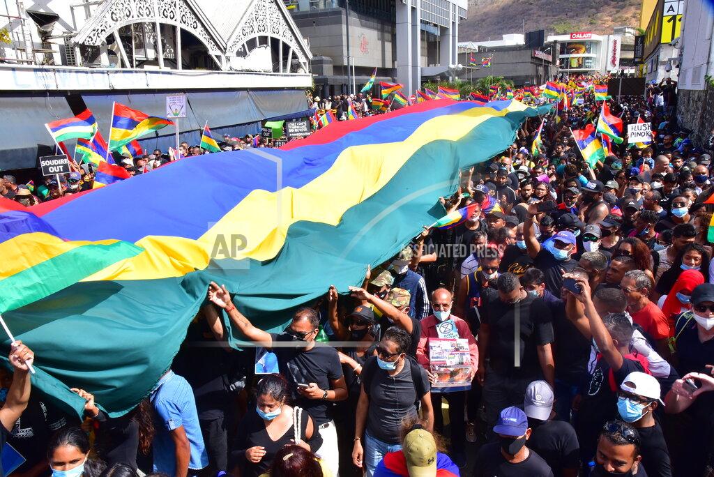 Beekash Roopun Tens of thousands of people protest in Port Louis, Mauritius, Saturday Aug. 29, 2020, over the government's slow response to an oil spill from a grounded Japanese ship and the alarming discovery of dozens of dead dolphins. (Beekash Roopun/L'express Maurice via AP)
