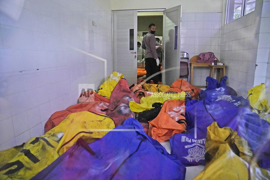 Dita Alangkara A police officer stands near body bags containing the bodies of the victims of a prison fire at the local hospital's morgue in Tangerang on the outskirts of Jakarta, Indonesia, Wednesday, Sept. 8, 2021. A massive fire raged through an overcrowded prison near Indonesia's capital early Wednesday, killing a number of inmates. (AP Photo/Dita Alangkara)