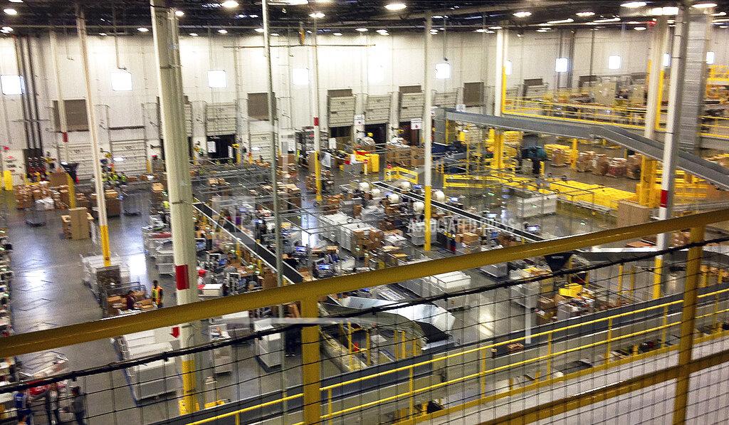 Brandon Bailey FILE - This Nov. 30, 2014, file photo shows an Amazon's distribution center in Tracy, Calif. California Attorney General Xavier Becerra on Monday, Dec. 14, 2020, asked a judge to order Amazon to comply with subpoenas his office issued nearly four months ago as part of an investigation into how the company is protecting workers from the coronavirus at its facilities. (AP Photo/Brandon Bailey, File)
