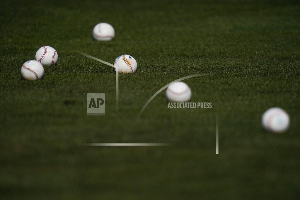 Jae C. Hong Batting practice balls are scattered on the field during the Arizona Diamondbacks' spring training baseball workout in Scottsdale, Ariz., Thursday, Feb. 25, 2021. (AP Photo/Jae C. Hong)
