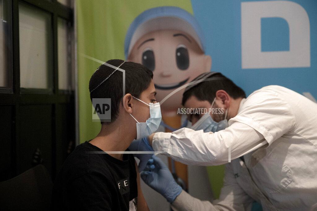 Maya Alleruzzo A 14-year-old Israeli receives a booster shot of the coronavirus vaccine at Clalit Health Service's center in the Cinema City complex in Jerusalem, Wednesday, Sept. 22, 2021. Israel is pressing ahead with its aggressive campaign of offering coronavirus boosters to almost anyone over 12 and says its approach was further vindicated by a U.S. decision to give the shots to older patients or those at higher risk. (AP Photo/Maya Alleruzzo)