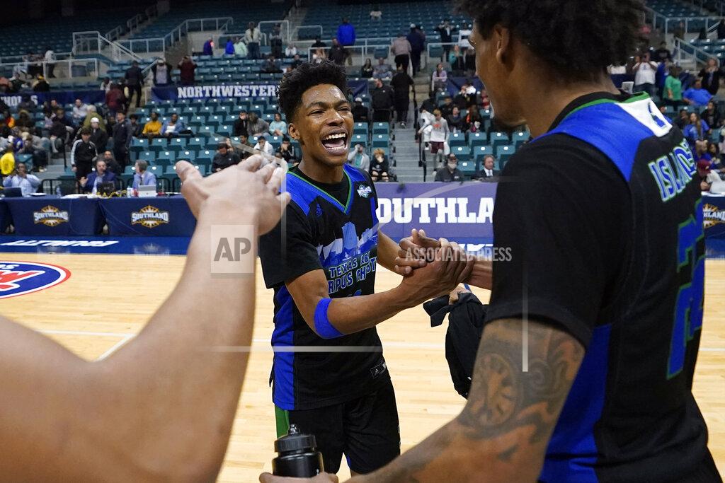 David J. Phillip Texas A&M Corpus Christi's Terrion Murdix, center, celebrates with Simeon Fryer, right, after the Southland Conference tournament NCAA college basketball game final against the Southeastern Louisiana Saturday, March 12, 2022, in Katy, Texas. Texas A&M Corpus Christi won 73-65.(AP Photo/David J. Phillip)