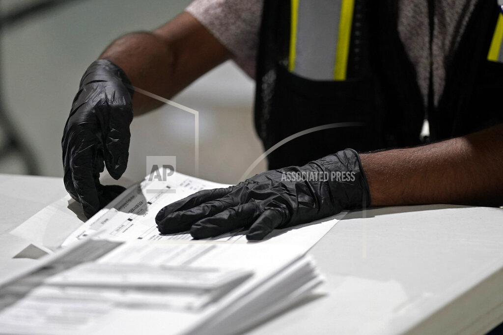 Gerry Broome FILE - A worker prepares absentee ballots for mailing at the Wake County Board of Elections in Raleigh, N.C., Sept. 3, 2020. North Carolina Democrats, accused by the Green Party of meddling in its petitioning process to qualify candidates for the November ballot, filed a lawsuit Wednesday, Aug. 3, 2022, asking a state court to overturn a unanimous elections board vote granting the Green Party official recognition despite allegations of fraud. (AP Photo/Gerry Broome, File)