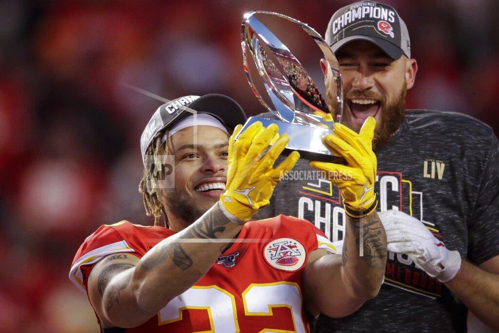 Charlie Riedel Kansas City Chiefs' Tyrann Mathieu and Travis Kelce hold up the Lamar Hunt Trophy after the NFL AFC Championship football game against the Tennessee Titans Sunday, Jan. 19, 2020, in Kansas City, MO. The Chiefs won 35-24 to advance to Super Bowl 54. (AP Photo/Charlie Riedel)