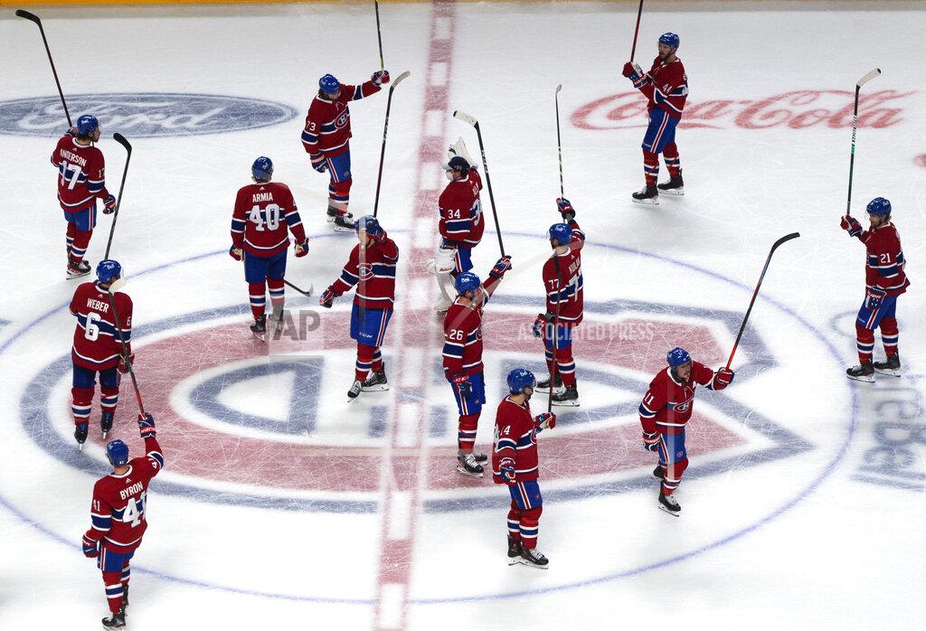 Ryan Remiorz Montreal Canadiens players salute the fans after defeating the Toronto Maple Leafs 3-2 in overtime in Game 6 of an NHL hockey Stanley Cup first-round playoff seres Saturday, May 29, 2021, in Montreal. (Ryan Remiorz/The Canadian Press via AP)