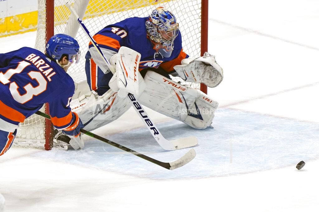 Kathy Willens New York Islanders center Mathew Barzal (13) and goaltender Semyon Varlamov (40) defend against the Washington Capitals during the first period of an NHL hockey Thursday, April 22, 2021, in Uniondale, N.Y. (AP Photo/Kathy Willens)