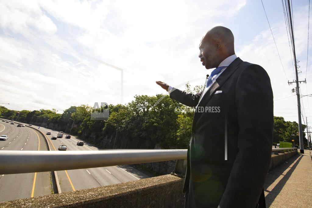 John Amis Tennessee State Rep. Harold Love, Jr. gestures toward an area he is supporting to expand a bridge and make a cap over I-40, Monday, July, 19, 2021, on the north side of Nashville, Tenn. Love Jr.'s father, a Nashville city councilman, was forced to sell his family home nearby, to make way for the highway, but put up a fight in the 1960s against the rerouting of Interstate 40 because he believed it would stifle and isolate Nashville's Black community. (AP Photo/John Amis)