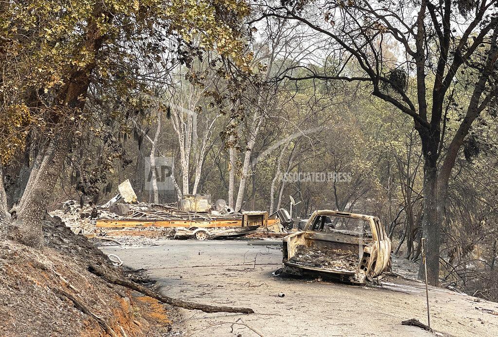 Elias Funez Charred metal and ash are all that remain of "Pete" Reyna's Chicago Park home which burned Wednesday night due to the River Fire, Aug. 7, 2021. (Elias Funez/The Union via AP)