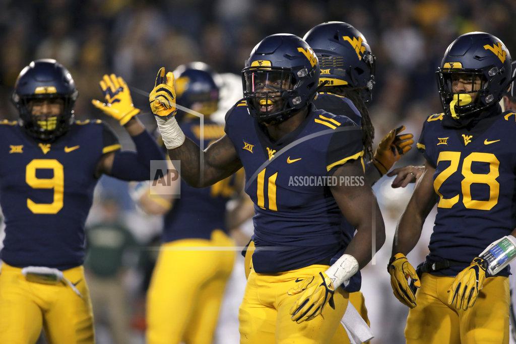 Ray Thompson FILE - In this Oct. 25, 2018, file photo, West Virginia linebacker David Long Jr. (11) celebrates with teammates after sacking Baylor's quarterback during the first half of an NCAA college football game, in Morgantown, W.Va. David Long Jr. was selected defensive player of the year when the AP All-Big 12 team was announced Friday, Dec. 7, 2018. (AP Photo/Raymond Thompson, File)