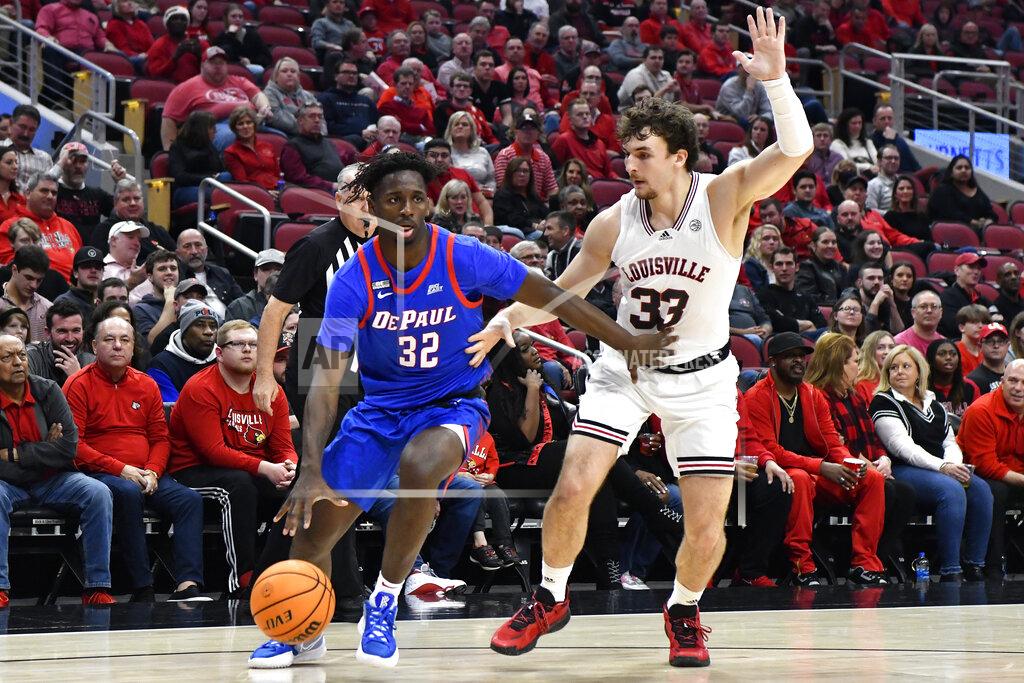 Timothy D. Easley DePaul forward David Jones (32) drives around Louisville forward Matt Cross (33) during the first half of an NCAA college basketball game in Louisville, Ky., Friday, Dec. 10, 2021. (AP Photo/Timothy D. Easley)