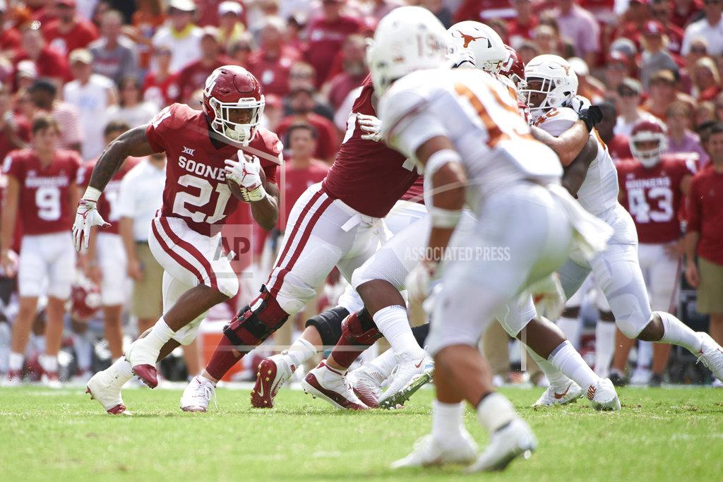 Cooper Neill Oklahoma running back Marcelias Sutton (21) breaks free against Texas during the second half of an NCAA college football game at the Cotton Bowl, Saturday, Oct. 6, 2018, in Dallas. (AP Photo/Cooper Neill)