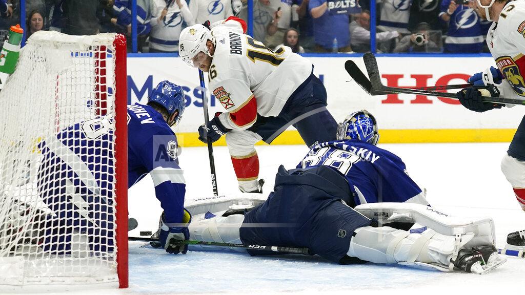 Chris O'MEara Tampa Bay Lightning goaltender Andrei Vasilevskiy (88) and defenseman Mikhail Sergachev (98) team up to stop a shot by Florida Panthers center Aleksander Barkov (16) during the third period in Game 4 of an NHL hockey second-round playoff series Monday, May 23, 2022, in Tampa, Fla. (AP Photo/Chris O'Meara)