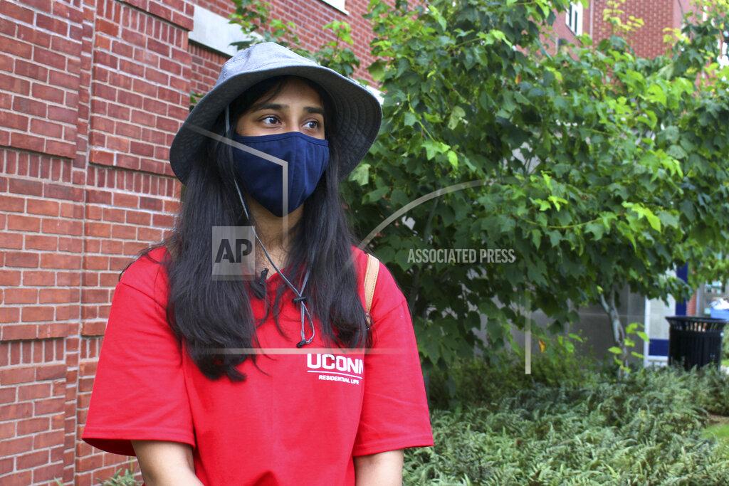 Pat Eaton-Robb UConn sophomore Sahiti Bhyravavajhala assists students moving into Shippee Hall on the Storrs, Conn. campus, Friday, Aug. 27, 2021. UConn is one of many schools across the nation mandating that returning students be vaccinated against COVID-19. An analysis by The Associated Press shows 26 of the nation's 50 largest public universities aren't requiring the vaccination. (AP Photo/Pat Eaton-Robb)