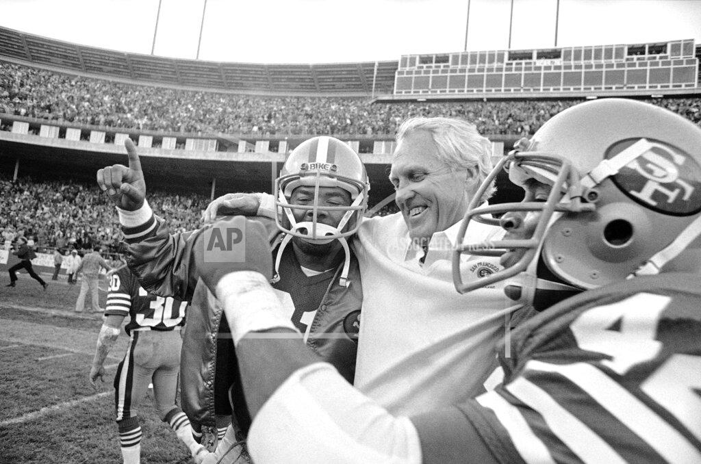 Carl Viti FILE - In this Nov. 29, 1981 file photo, San Francisco 49ers coach Bill Walsh is hugged by 49ers back Walt Easley, left, and 49ers back Ronnie Lott after beating the New York Giants 17-10 to clinch the division title at Candlestick Park in San Francisco. What doach Kyle Shanahan, quarterback Jimmy Garoppolo, defensive end Nick Bosa and the rest of the San Francisco 49ers are doing this year harkens back to 1981 when Bill Walsh, Joe Montana and Ronnie Lott led the franchise to its first Super Bowl title. (AP Photo/Carl Viti)