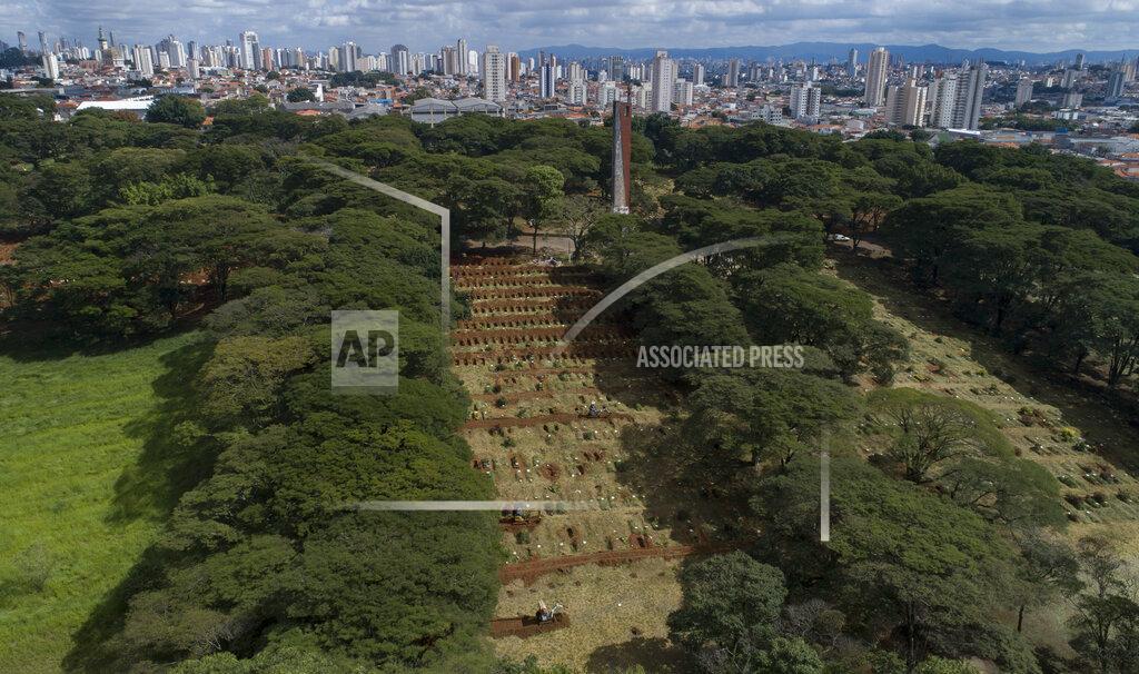 Andre Penner Workers use small bulldozers to dig more graves amid the COVID-19 pandemic at the Vila Formosa cemetery in Sao Paulo, Brazil, Wednesday, April 7, 2021. The city of Sao Paulo started on Wednesday the digging of 600 additional graves every day in its municipal cemeteries. (AP Photo/Andre Penner)
