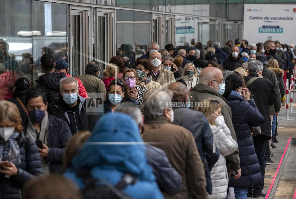 Manu Fernandez People queue to be vaccinated with the AstraZeneca vaccine against COVID-19 during a vaccination campaign at WiZink indoor arena in Madrid, Spain, Friday, April 9, 2021. Madrid is expanding its mass COVID-19 vaccination program, with jabs being administered from Friday at the city's large WiZink indoor arena. Some 4,000 people between 60 and 65 years of age were due to receive the AstraZeneca vaccine there on the first day. (AP Photo/Manu Fernandez)