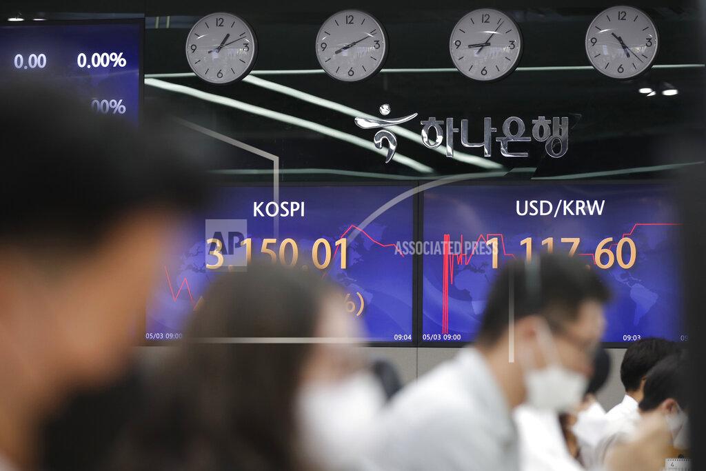 Currency traders work near screens showing the Korea Composite Stock Price Index (KOSPI), left, and the foreign exchange rate between U.S. dollar and South Korean won at a bank's foreign exchange dealing room in Seoul, South Korea, Monday, May 3, 2021. Shares were mostly lower in Asia in thin trading Monday, with many markets including those in Tokyo and Shanghai closed for holidays. (AP Photo/Lee Jin-man)