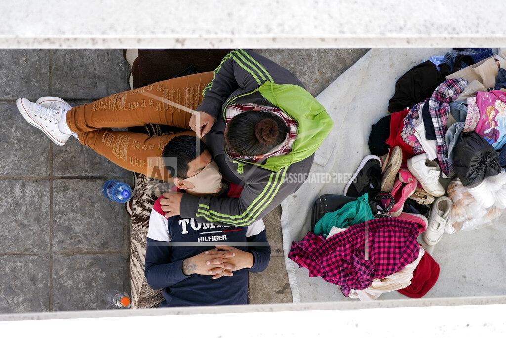 Julio Cortez Migrants who were caught trying to sneak into the United States and deported rest under a ramp that leads to the McAllen-Hidalgo International Bridge point of entry into the U.S., Thursday, March 18, 2021, in Reynosa, Mexico. A surge of migrants on the Southwest border has the Biden administration on the defensive. The head of Homeland Security acknowledged the severity of the problem Tuesday but insisted it's under control and said he won't revive a Trump-era practice of immediately expelling teens and children. (AP Photo/Julio Cortez)