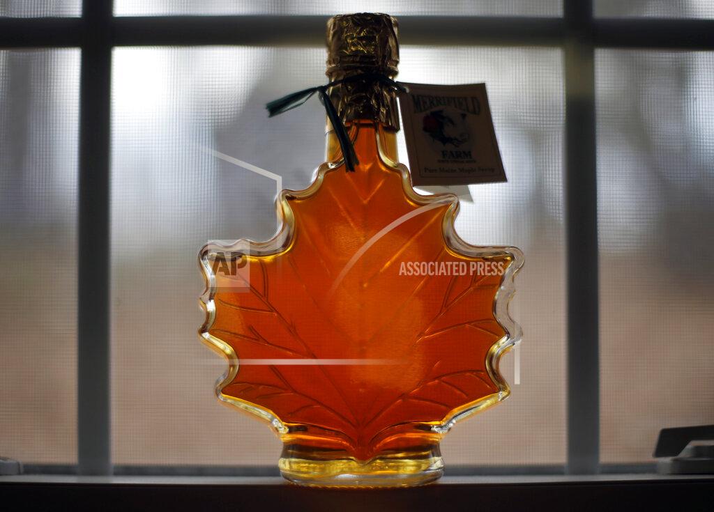 Robert F. Bukaty In this March 9, 2016, file photo, a bottle of maple syrup is displayed at the Merrifield Farm and Sugar Shack in Gorham, Maine. The coronavirus pandemic forced some states to cancel their annual maple season celebrations in 2020, but some New England producers with safety precautions in place are welcoming back the public in 2021. (AP Photo/Robert F. Bukaty, FIle)