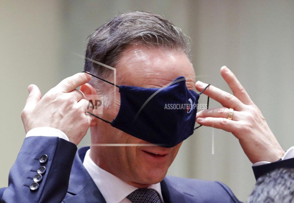 Stephanie Lecocq German Foreign Minister Heiko Maas puts on a face mask, to prevent the spread of coronavirus, as he attends an EU foreign ministers at the European Council building in Brussels, Monday, July 13, 2020. European Union foreign ministers meet for the first time face-to-face since the pandemic lockdown and will assess their discuss their relations with China and Turkey. (Stephanie Lecocq, Pool Photo via Ap)